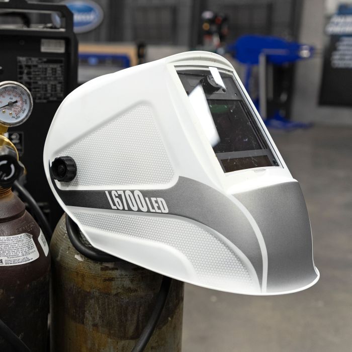 Eastwood L6700 LED Welding Helmet Hanging on Bottle in Shop