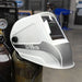 Eastwood L6700 LED Welding Helmet Hanging on Bottle in Shop