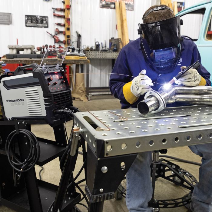 Operator using the Rockwood 180 AC/DC TIG welder in a fabrication workshop
