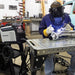 Operator using the Rockwood 180 AC/DC TIG welder in a fabrication workshop
