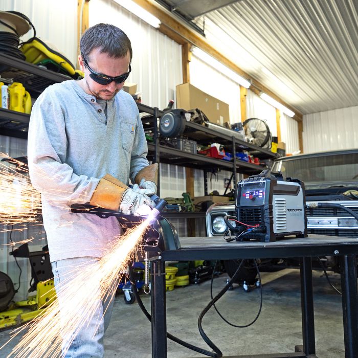 Operator using the Rockwood Plasma-Cut 40 plasma cutter in a fabrication shop
